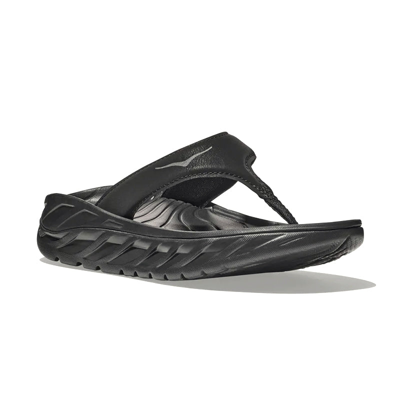 Angled side view of HOKA Women's Ora Recovery Flip in black/dark dull grey.