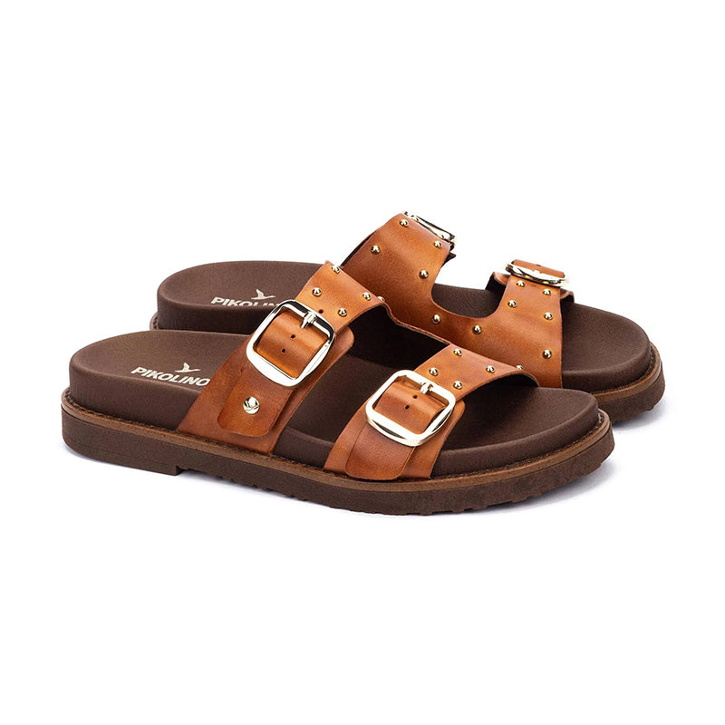 Pair of brown sandals with gold buckles on a white background