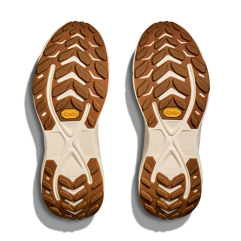Brown and beige shoe soles with a brand logo on a white background