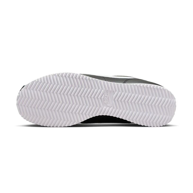 Bottom view of Nike Women's Cortez sneaker in black/white.