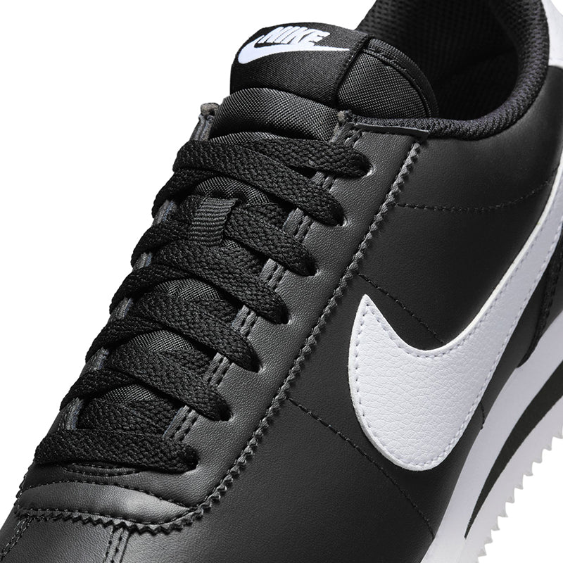 Zoomed in lace view of Nike Women's Cortez sneaker in black/white.