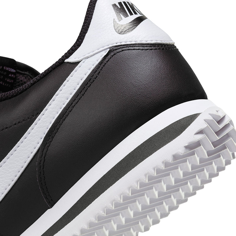 Zoomed in heel view of Nike Women's Cortez sneaker in black/white.