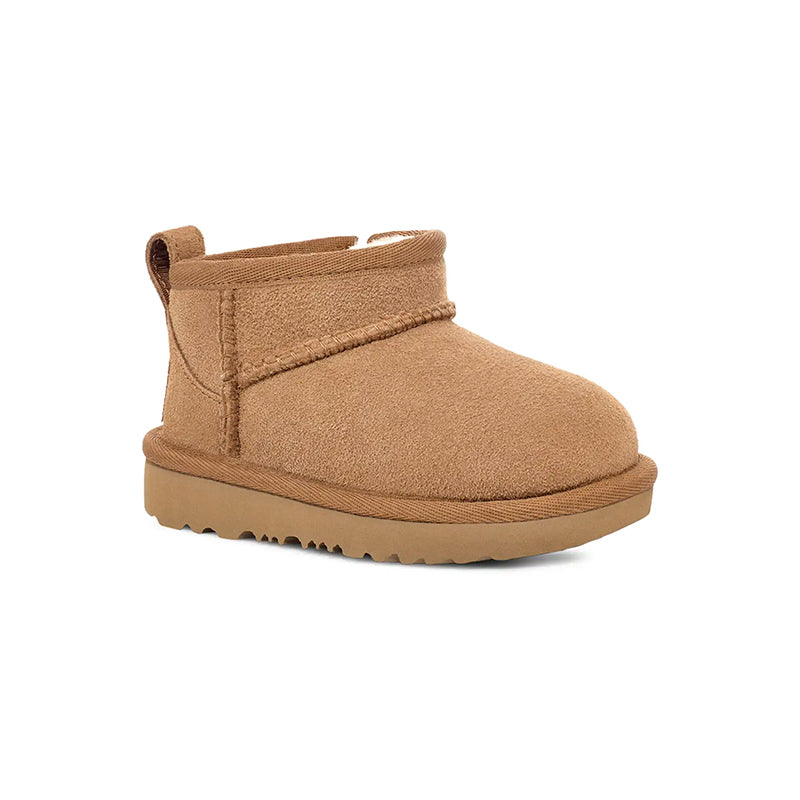 A chestnut-colored kid's preschool ultra mini ugg boot with a twinface sheepskin upper and a flexible sole.