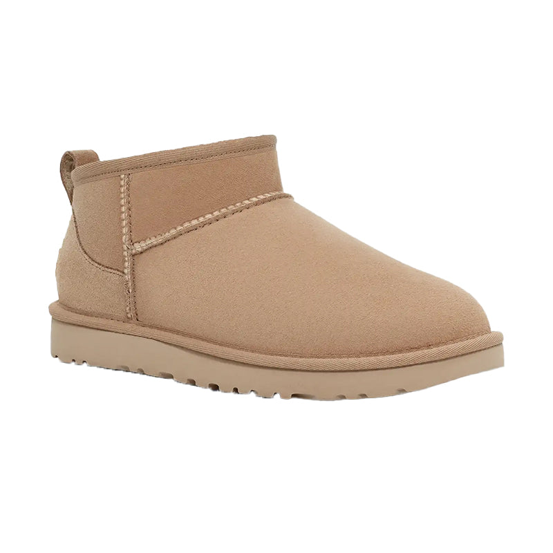 Angled side view of UGG Women's Classic Ultra Mini Boot in Sand.