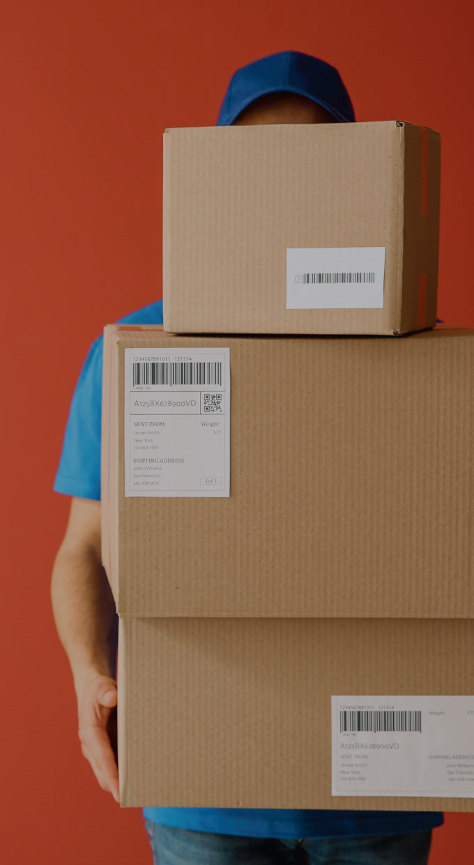 Man holding three boxes.