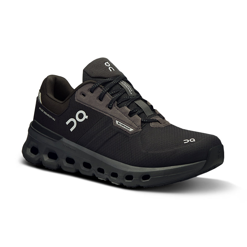 A black women's running shoe with a mesh upper and a distinctive sole featuring round cutouts.