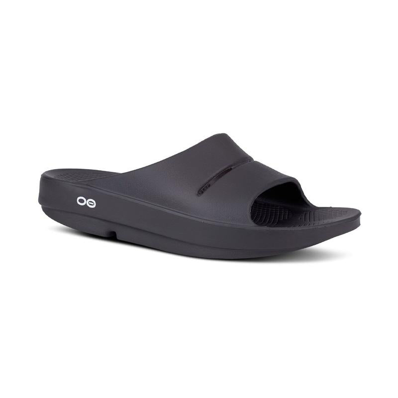 Angled side view of OOFOS Women's OOAHH slide in Black.